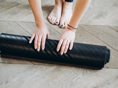 View of a yoga mat on a wooden floor.